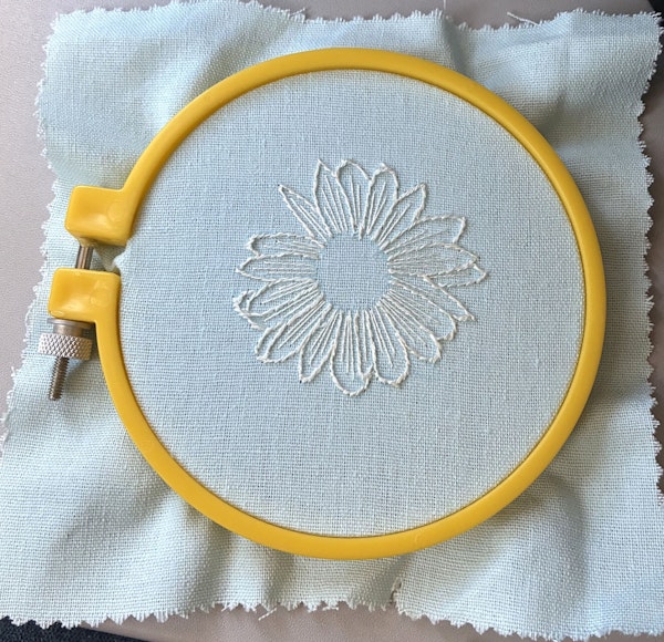 Outline with stem stich and detail the petals with straight stitch.