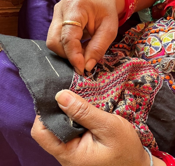 An embroidery artist stitches at a cooperative in Bhuj, Gujarat, India.