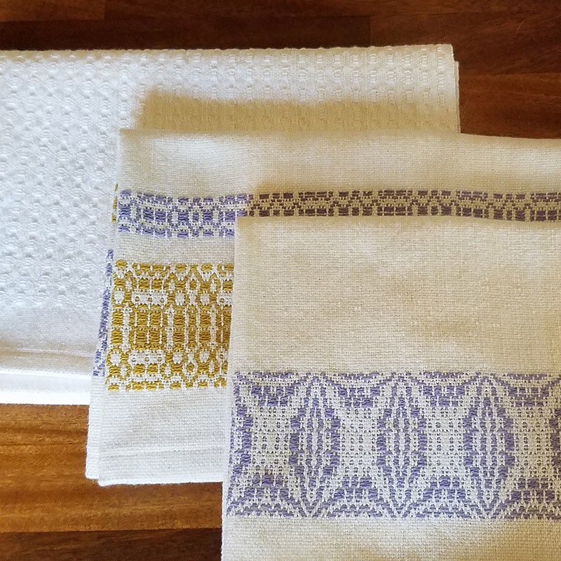 Shown from back: Huck ovals, Sweet and Lovely overshot bands, and Orange Peel overshot bands were the first towels from the warp.
