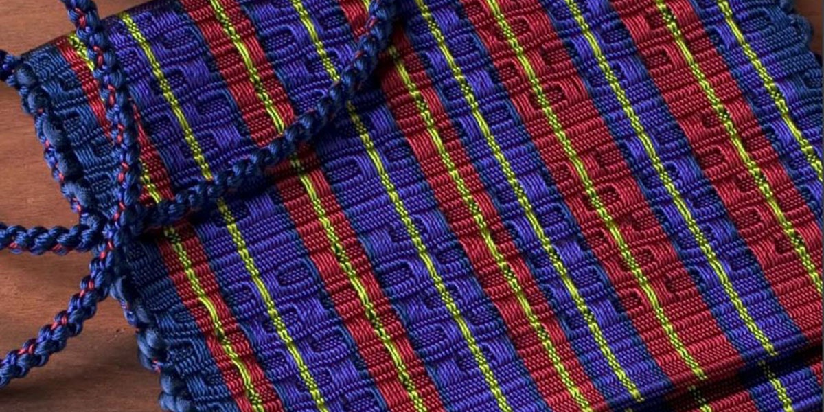 Rosalie Nielson‘s glimmering red, blue, and gold evening honeycomb and rep weave handbag. Photo by Joe Coca