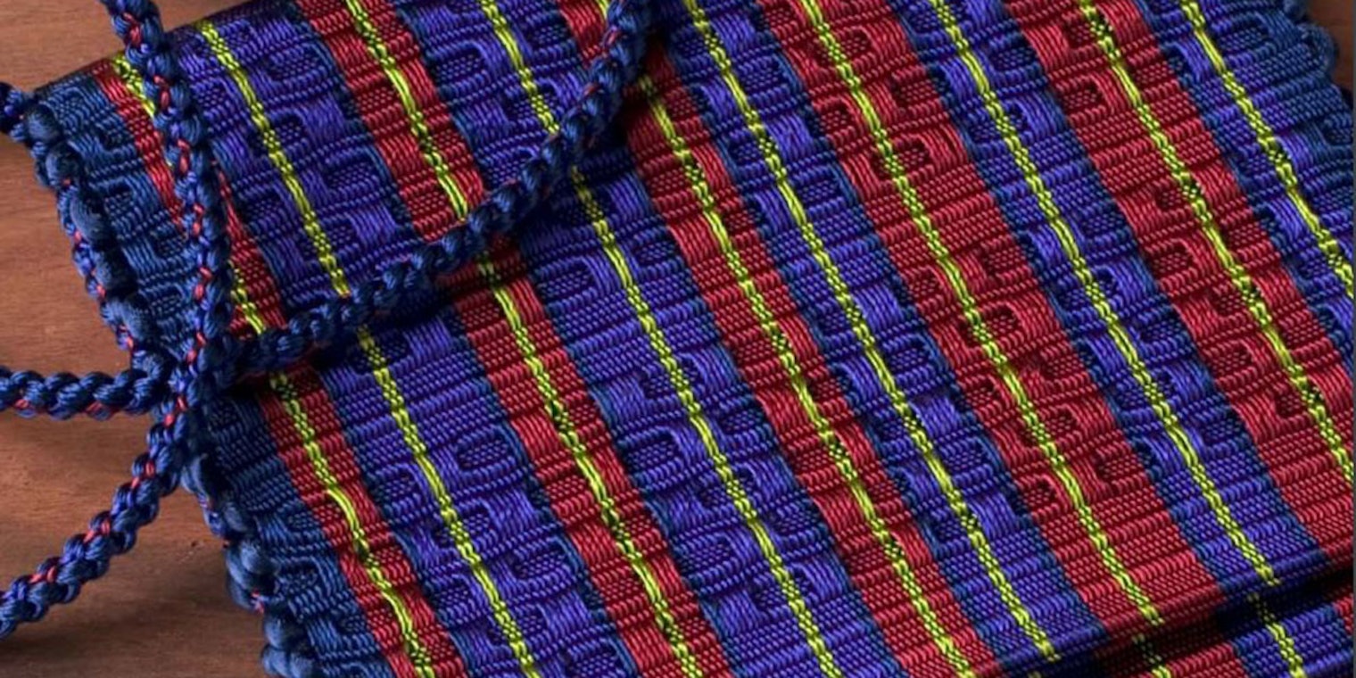 Rosalie Nielson‘s glimmering red, blue, and gold evening honeycomb and rep weave handbag. Photo by Joe Coca