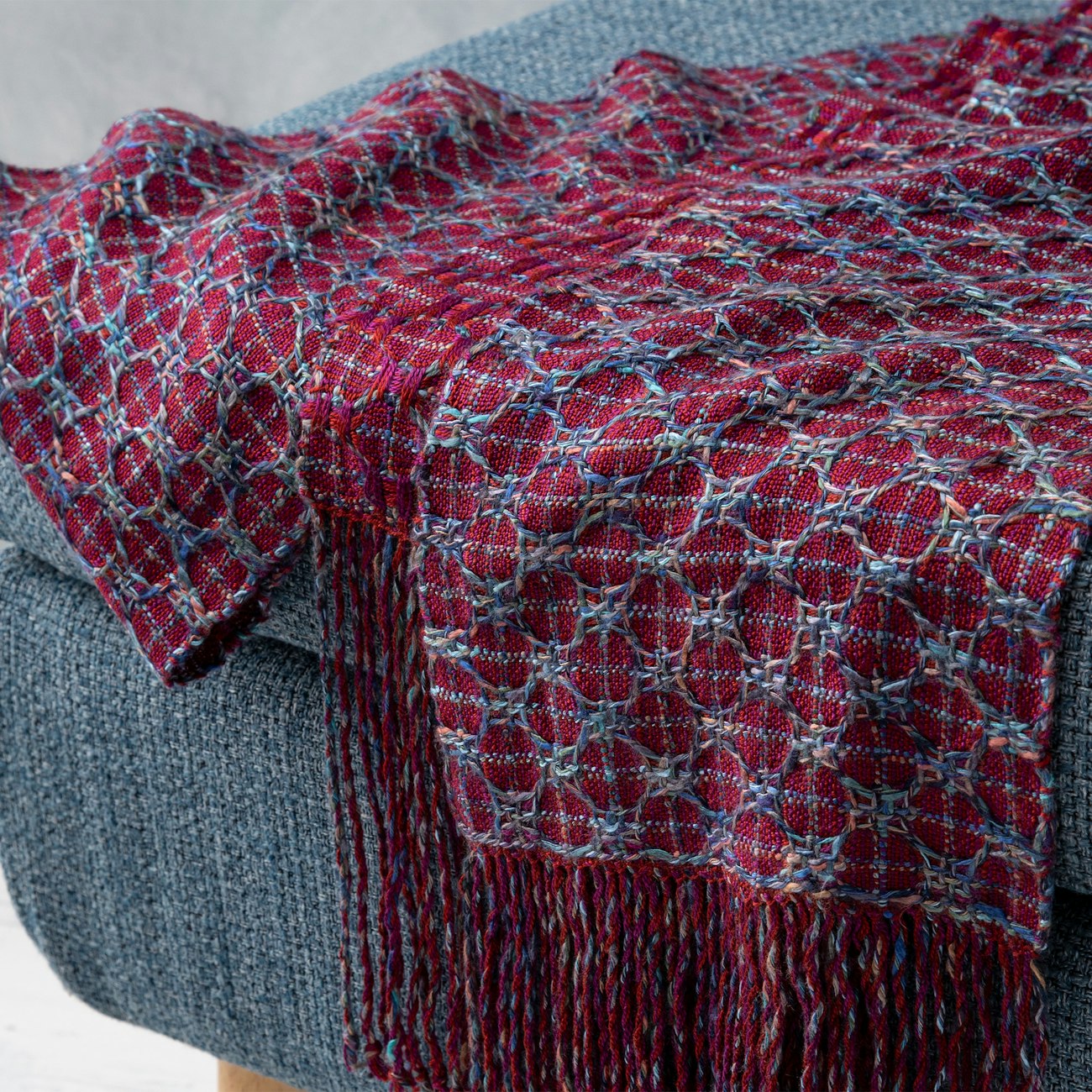 Choosing the right yarn made this honeycomb scarf possible, and we love how the colors are so complementary. Blue Circling Embers by Annette Swan Schipf from Handwoven Nov/Dec 2021. Photo by Matt Graves