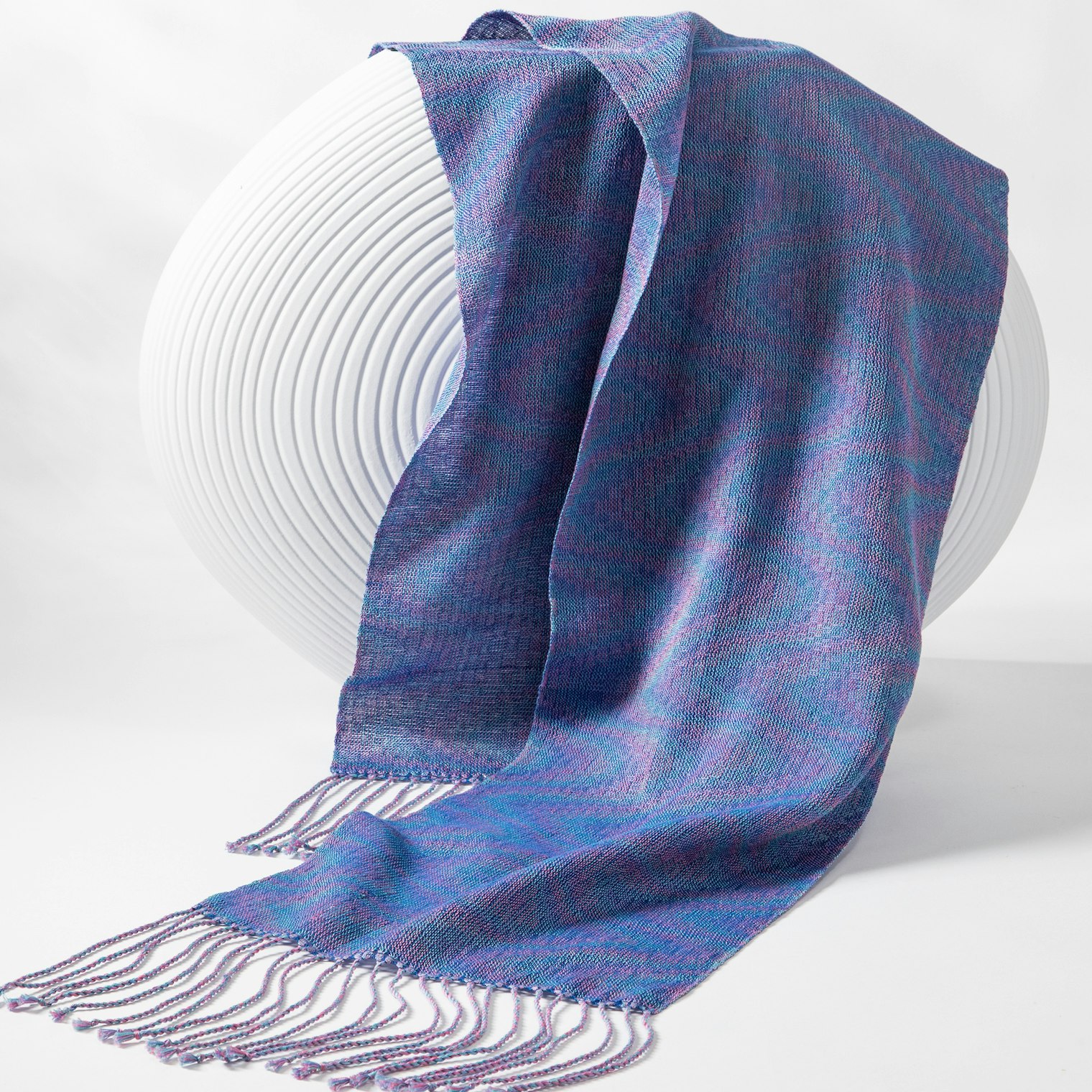 The Advancing Waves scarf uses 4 pastels in the warp with a darker weft in an advancing twill to create its wave-like designs. Photo by Matt Graves