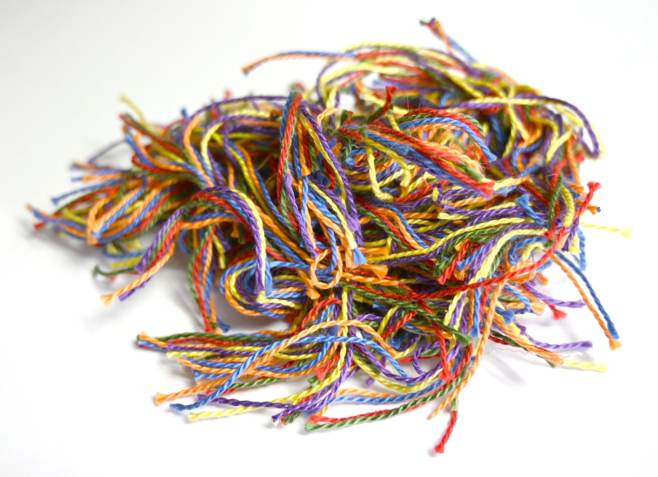 A pile of colorful trimmed threads