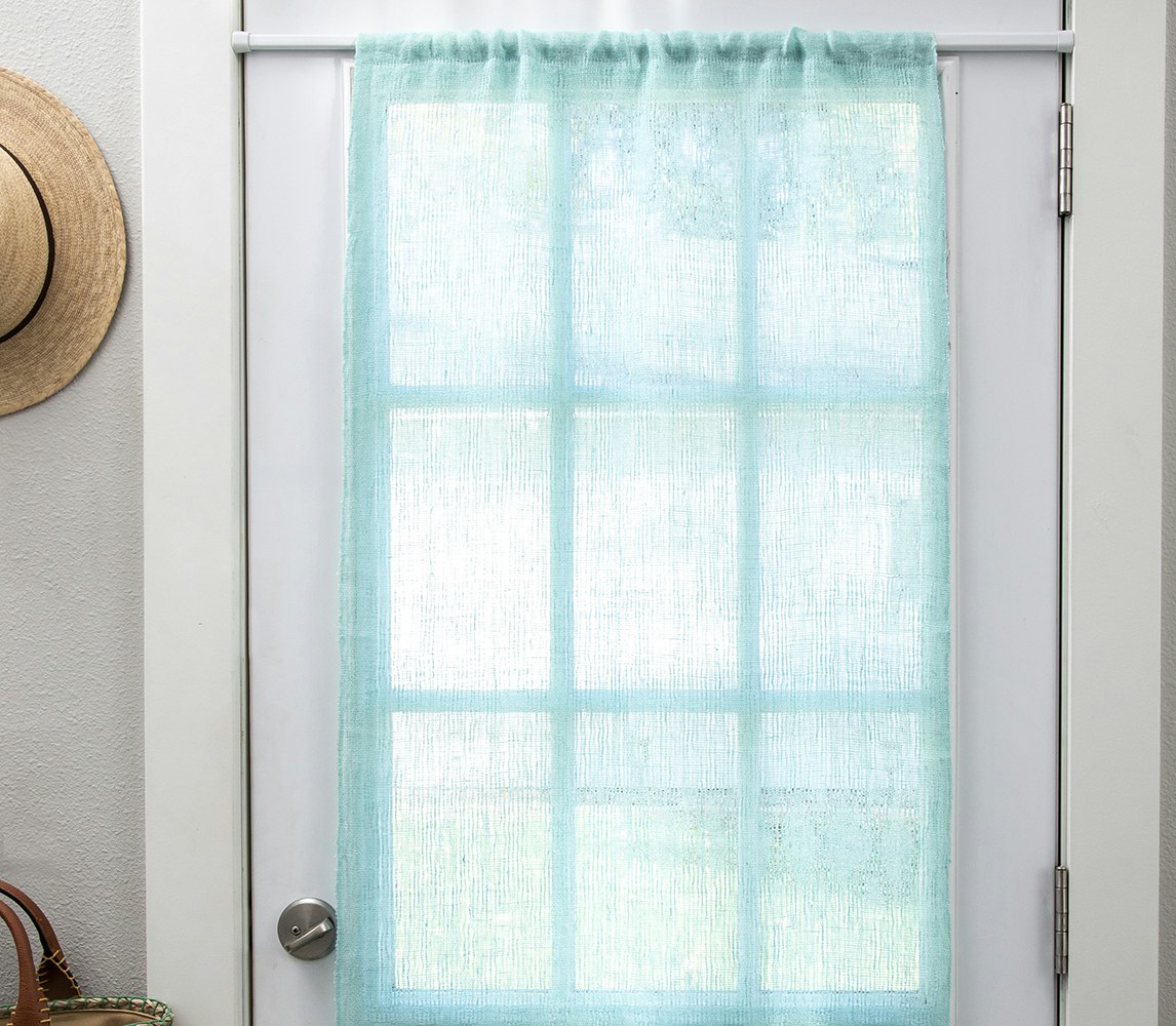A turquoise curtain hangs over a window.