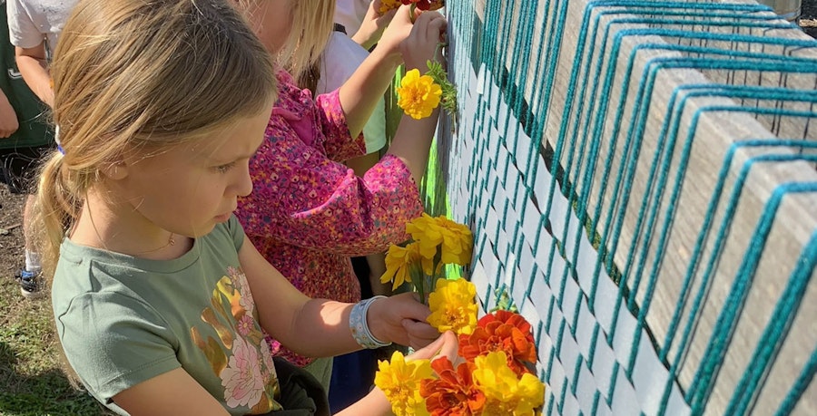 Weaving on a Flower-Filled Loom Image