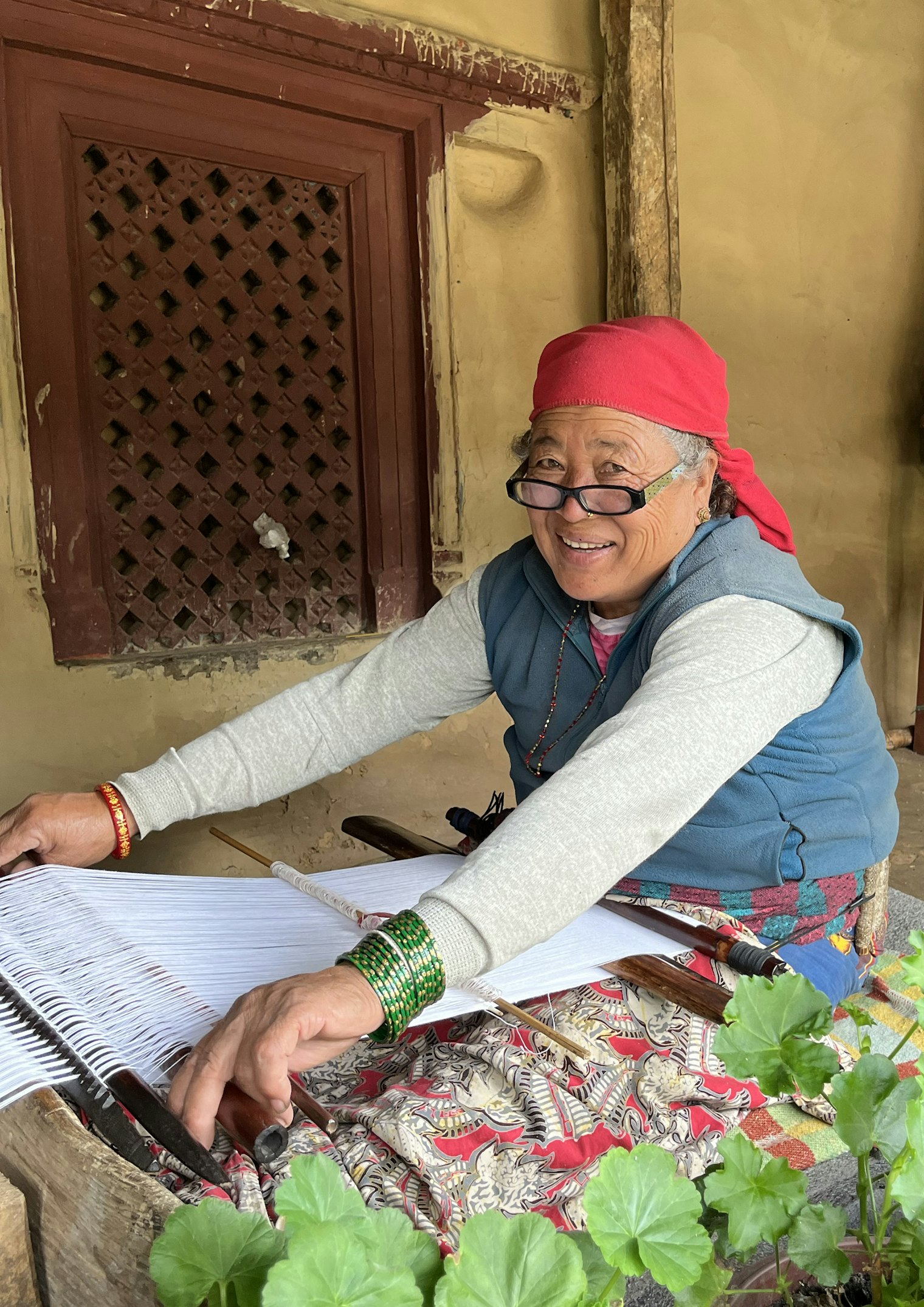 Gayni Gurung weaves bags on a backstrap loom. Traditionally these bags were made from handspun nettle fiber, but now they’re made with cotton.