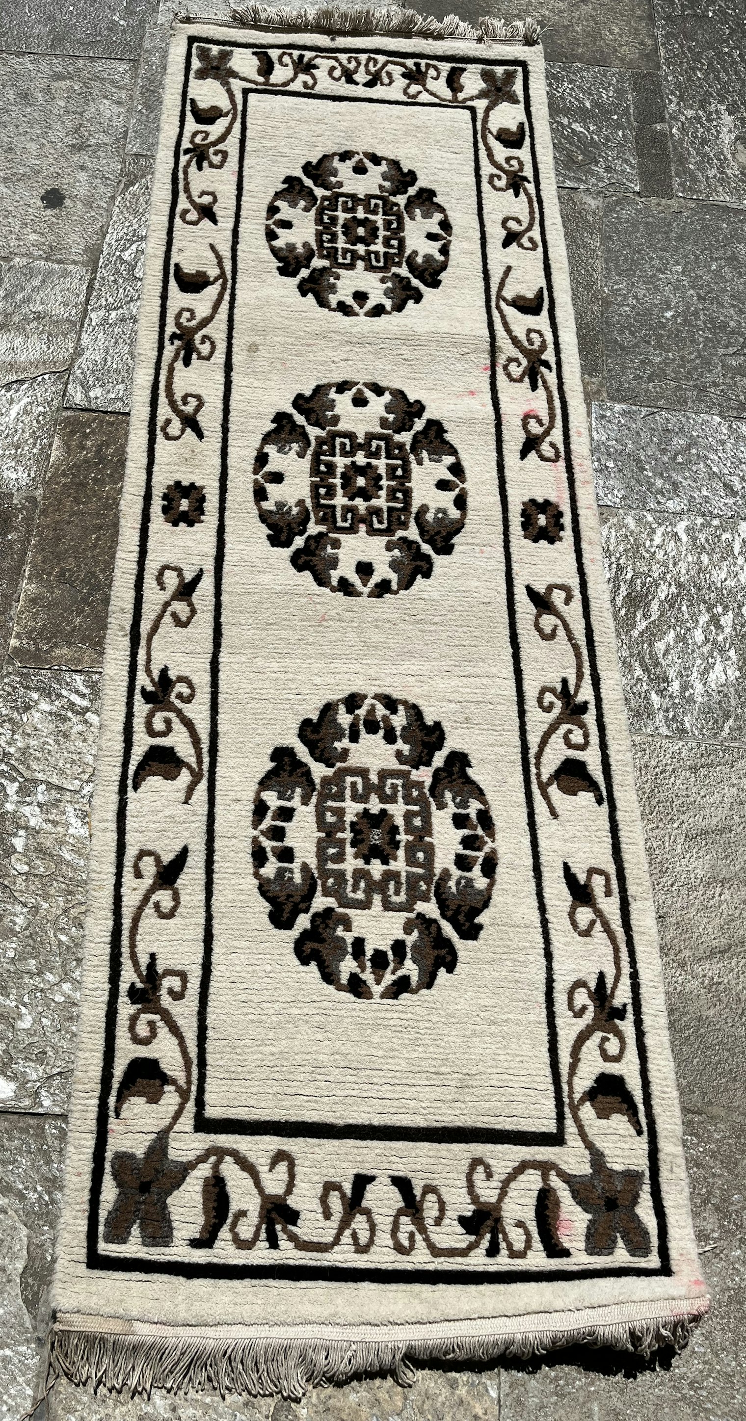 Kamyan Tapa wove this long galaicha with a Tibetan medallion design 35 years ago as a seating pad for honored guests, or for receiving Hindu tika blessings. From the collection of Maya Pun Thapa