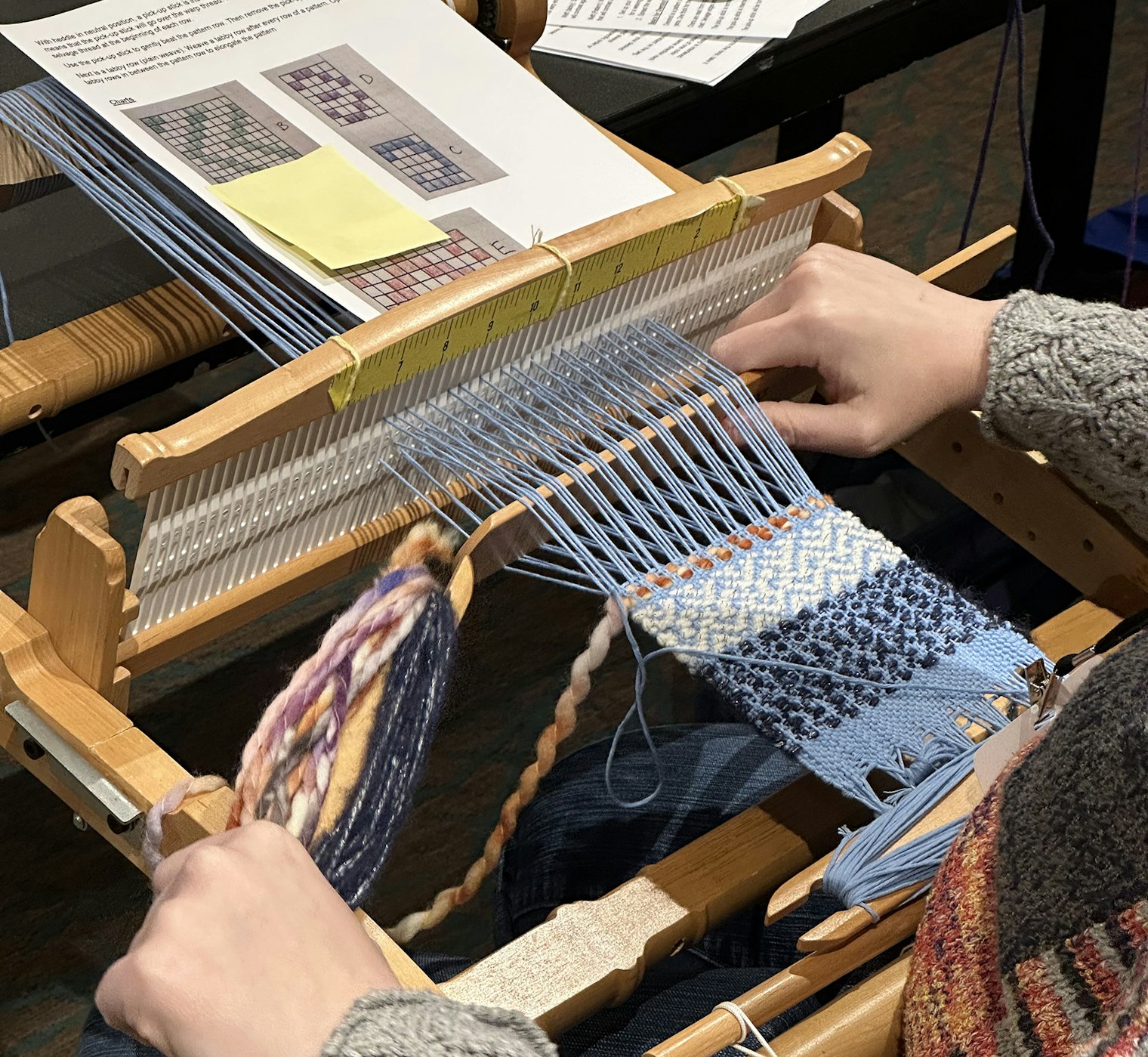 Weaving progress in Angela Tong‘s “Overshot on the Rigid-Heddle Loom” class.