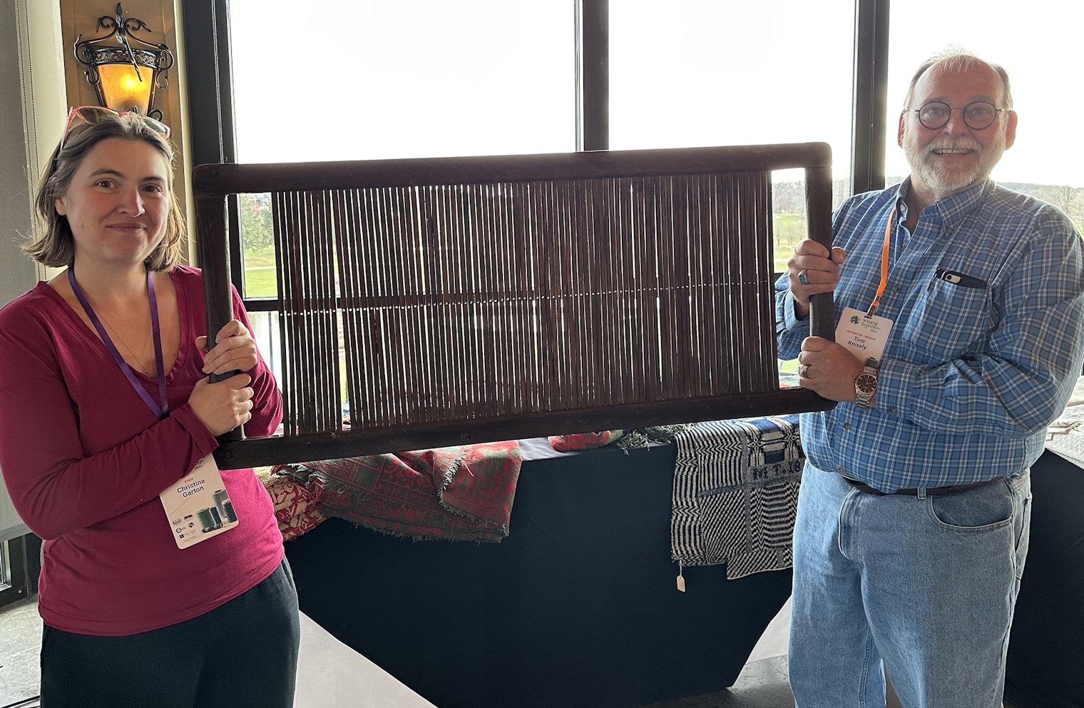 Christina Garton, editor of *Easy Weaving with Little Looms*, and Tom Knisely hold up a very large heddle. In an evening presentation, Tom shared tales of his work as a textile detective, including what he learned about that heddle.