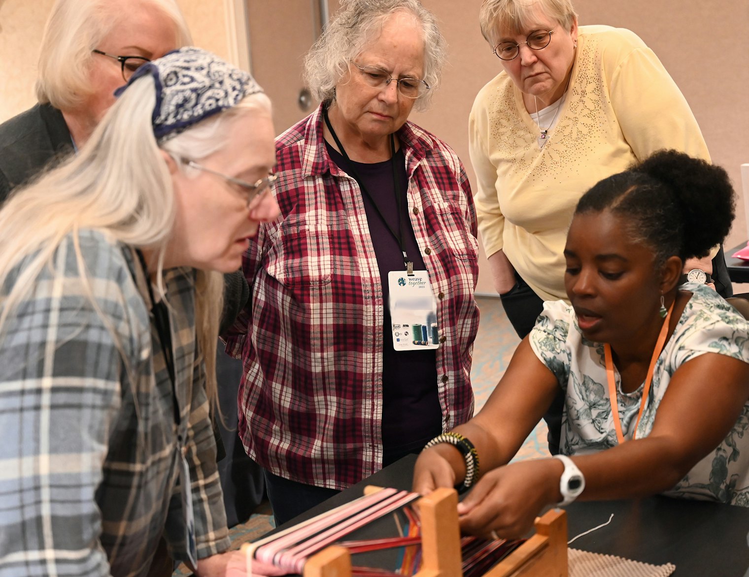 Jennifer B. Williams, right, teaches “Bedouin-Inspired Inkle Bands” on the inkle loom.