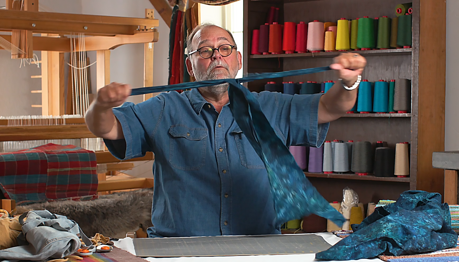 Tom is able to tear multiple strips of fabric at once, thanks to a few preliminary cuts.