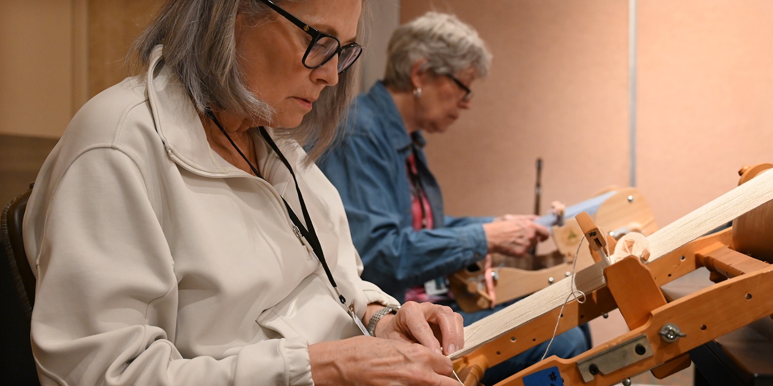 A weaver makes embellishments on the loom during a class at Weave Together 2025.