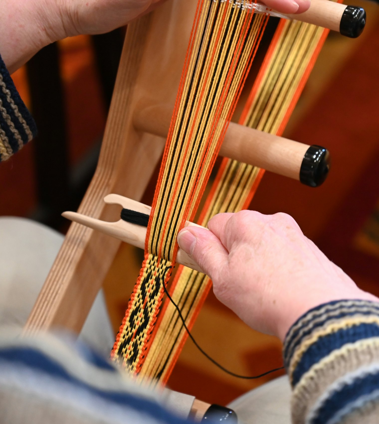 A speckled pick-up band being woven at Weave Together 2026.