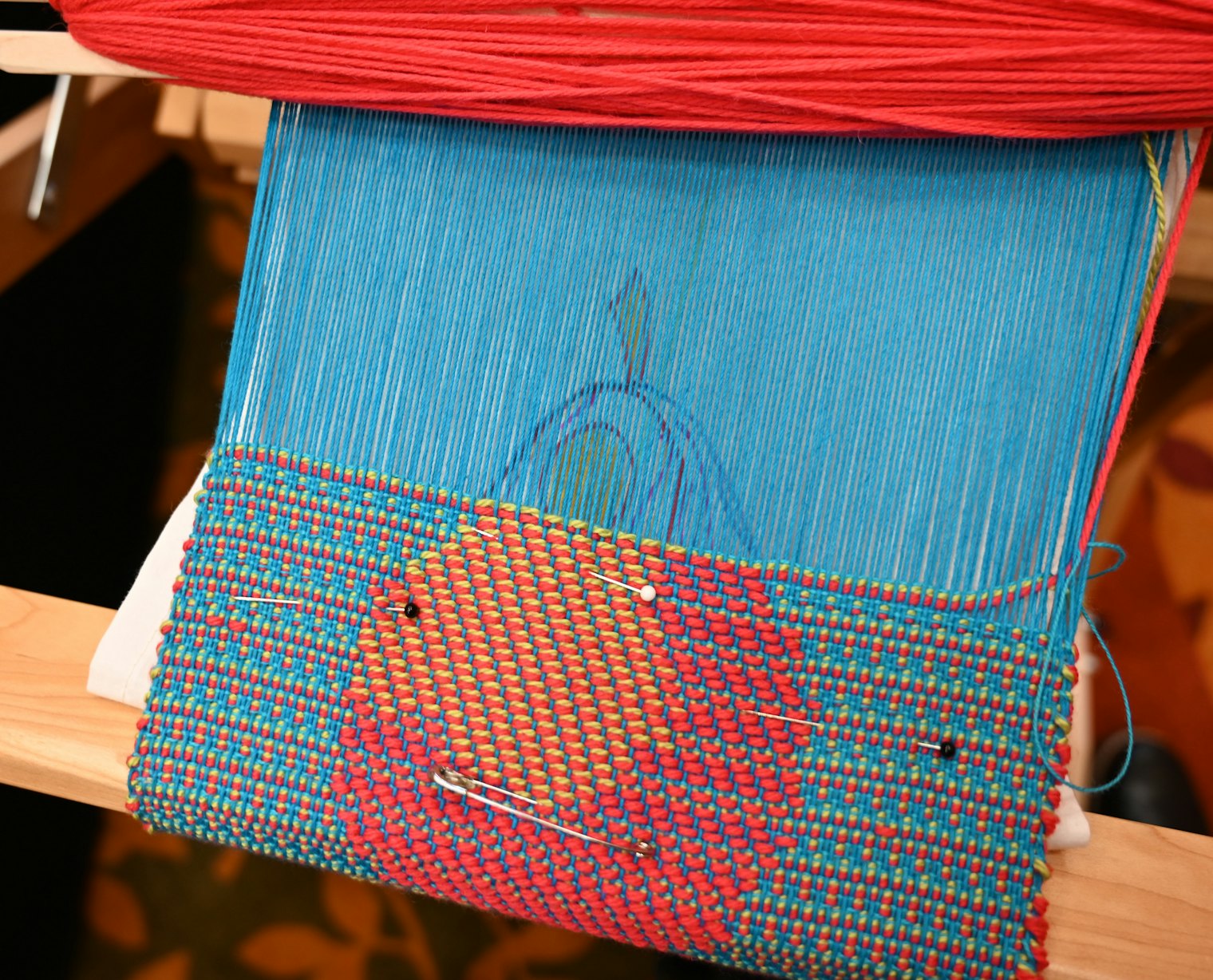 A pear mid-weaving during the split-shed class at Weave Together 2026.