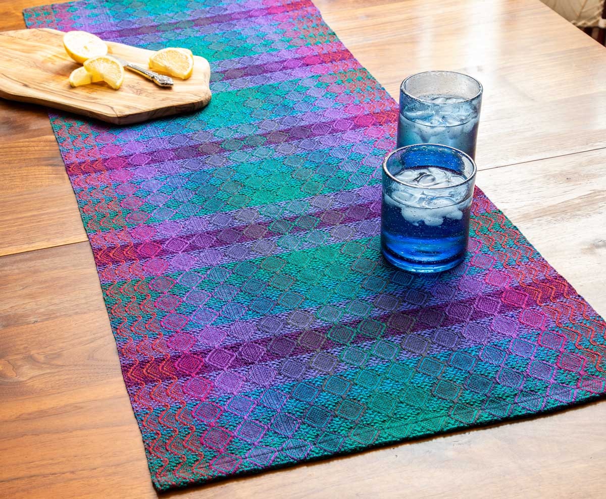 Sheila O’Hara’s Gemstone Table Runner, from the Summer 2026 issue, uses doubled ends for gradual color blending. Photo by Matt Graves