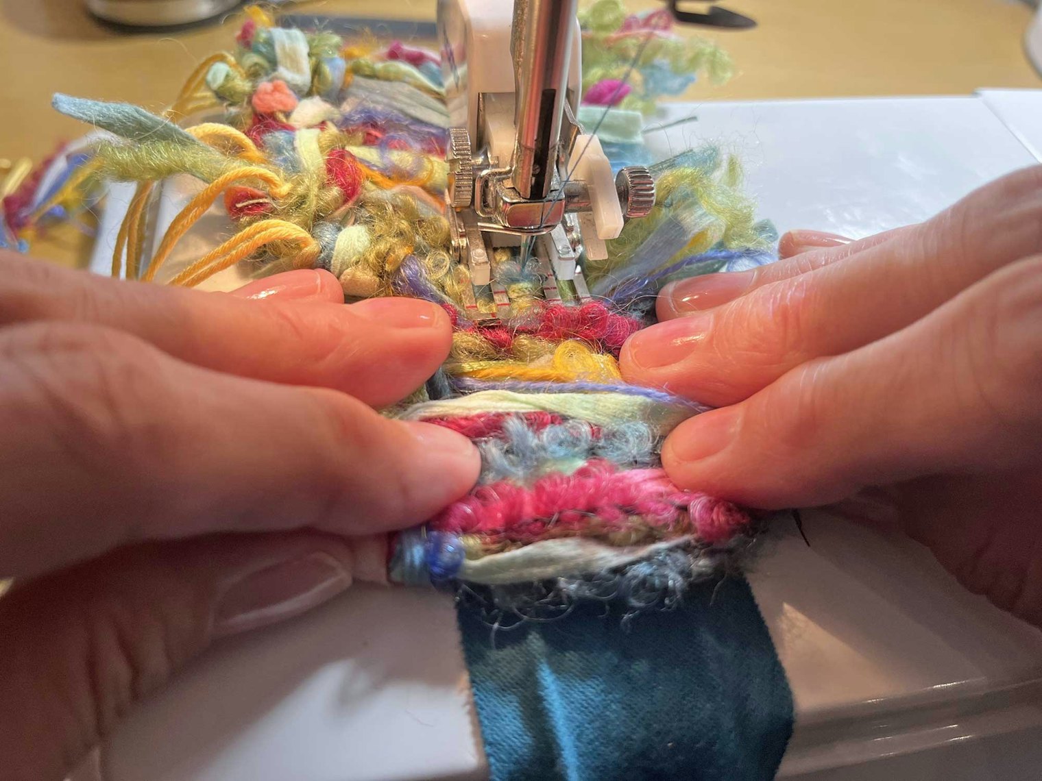 She stitched along the center of the bundles and the bias tape, working carefully to avoid catching loops of the bouclé yarns.