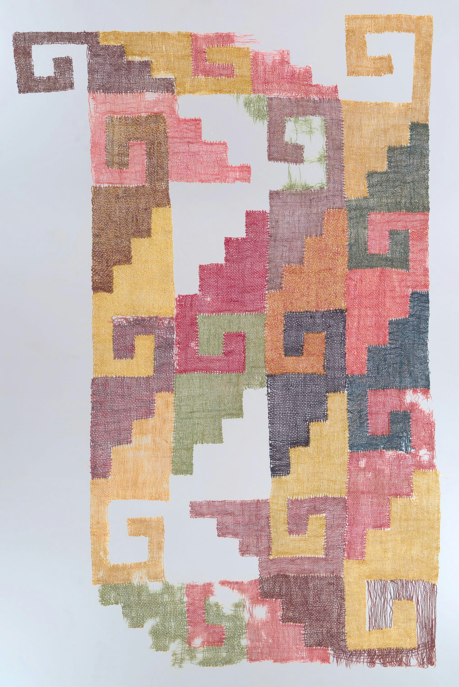 Fragment displaying stepped-fret motif woven in camelid wool and cotton. Plain weave of discontinuous single interlocking warps and wefts. Source: Nasca, South coast, Peru. About 200-500 CE. Courtesy of Art Institute of Chicago, CC0 license