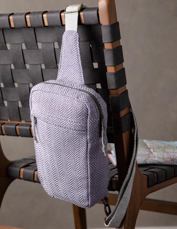 The sophisticated Adventurer’s Sling Bag, designed by Rachel Simmons, hangs over the shoulder on an inkle band. Photo by Matt Graves