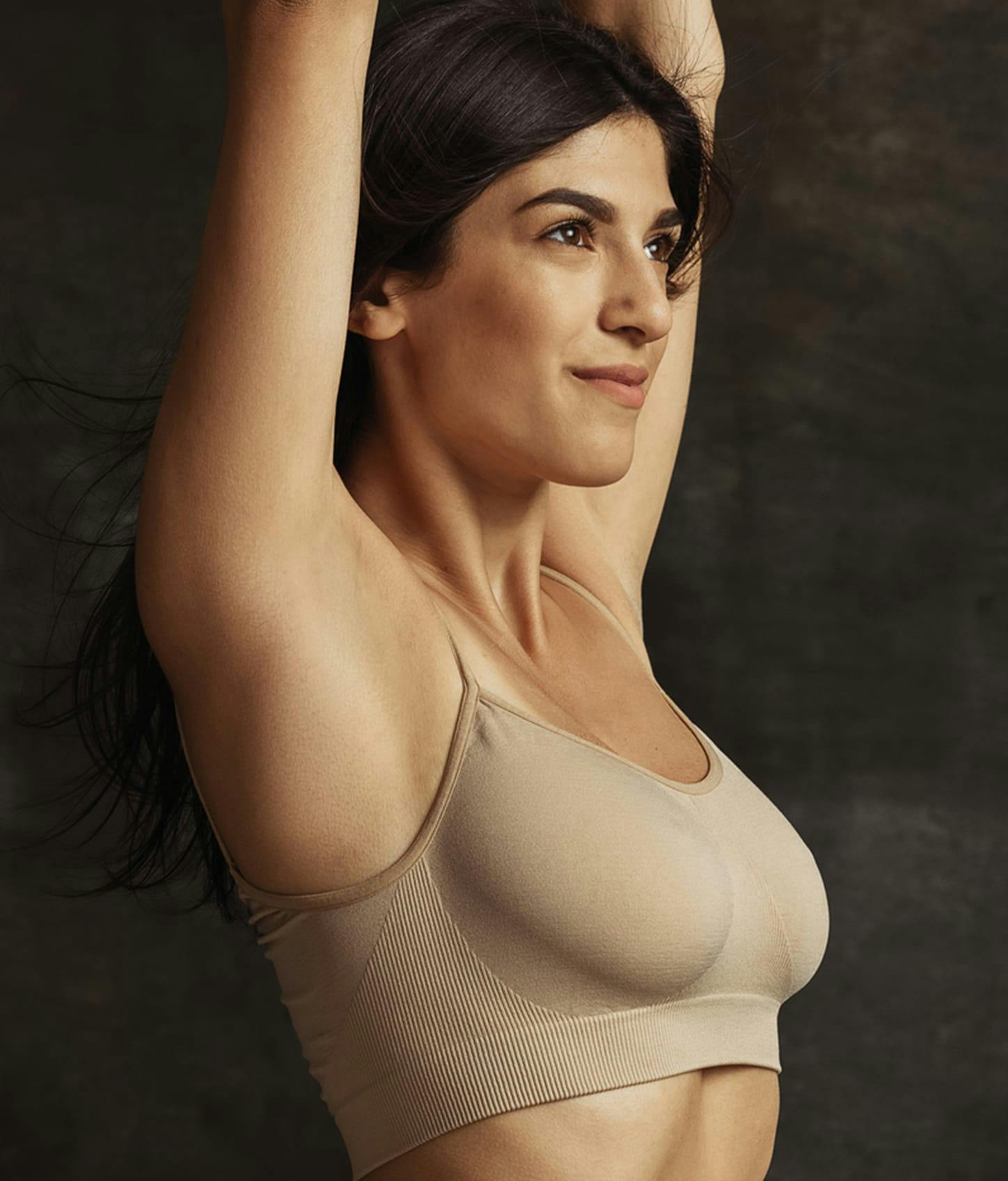 slim woman in beige sports bra