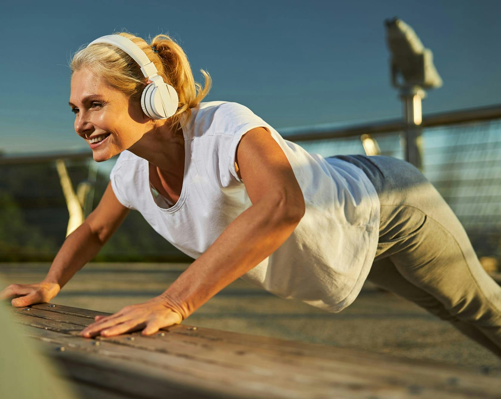 older, fit woman in headphones