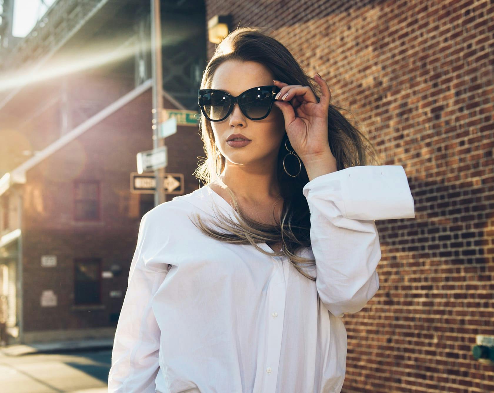 beautiful woman in white blouse and sun glasses