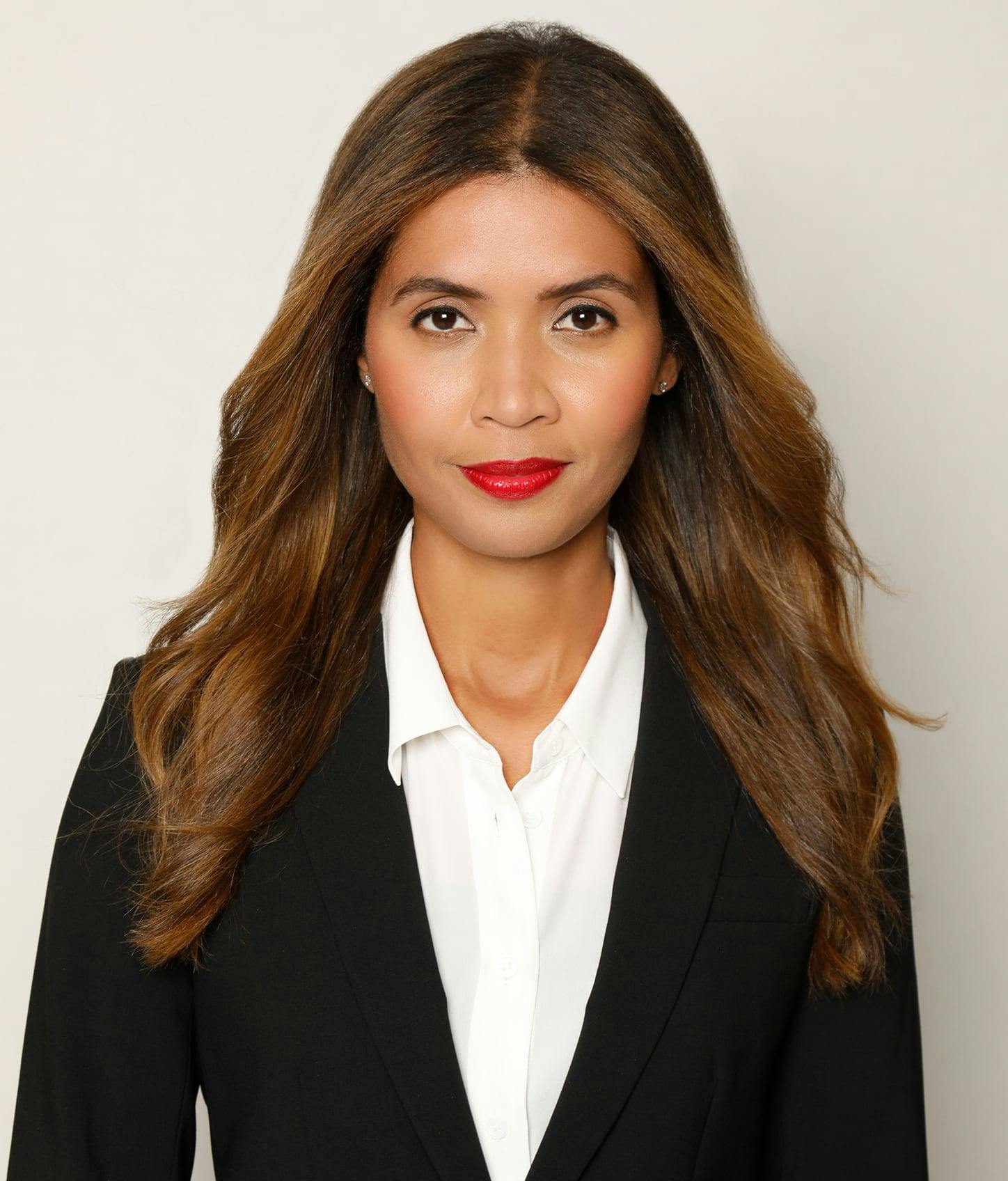 Dr. K in a black blazer and white blouse