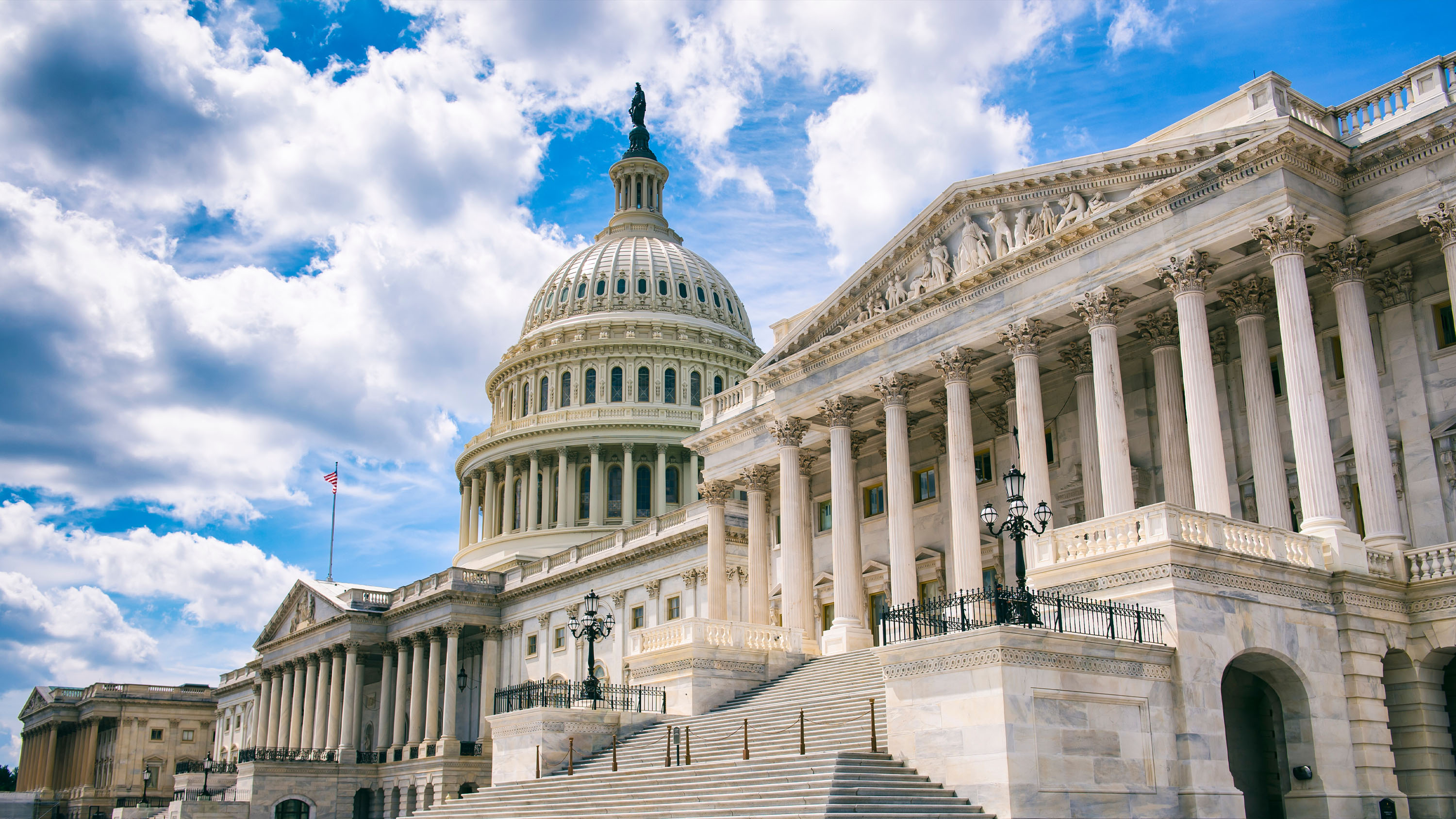 Image of government buildings with blue sky and clouds