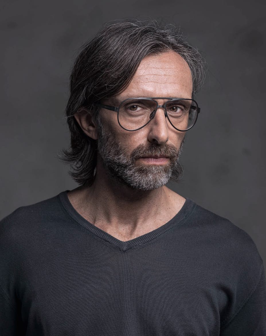 The model is wearing Serpico Ruthenium glasses with vision lenses