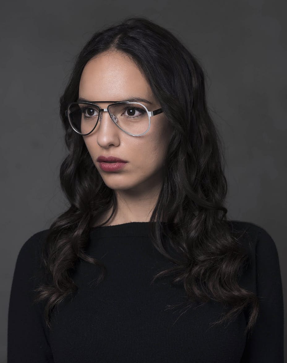 The model is wearing Serpico Palladium glasses with vision lenses