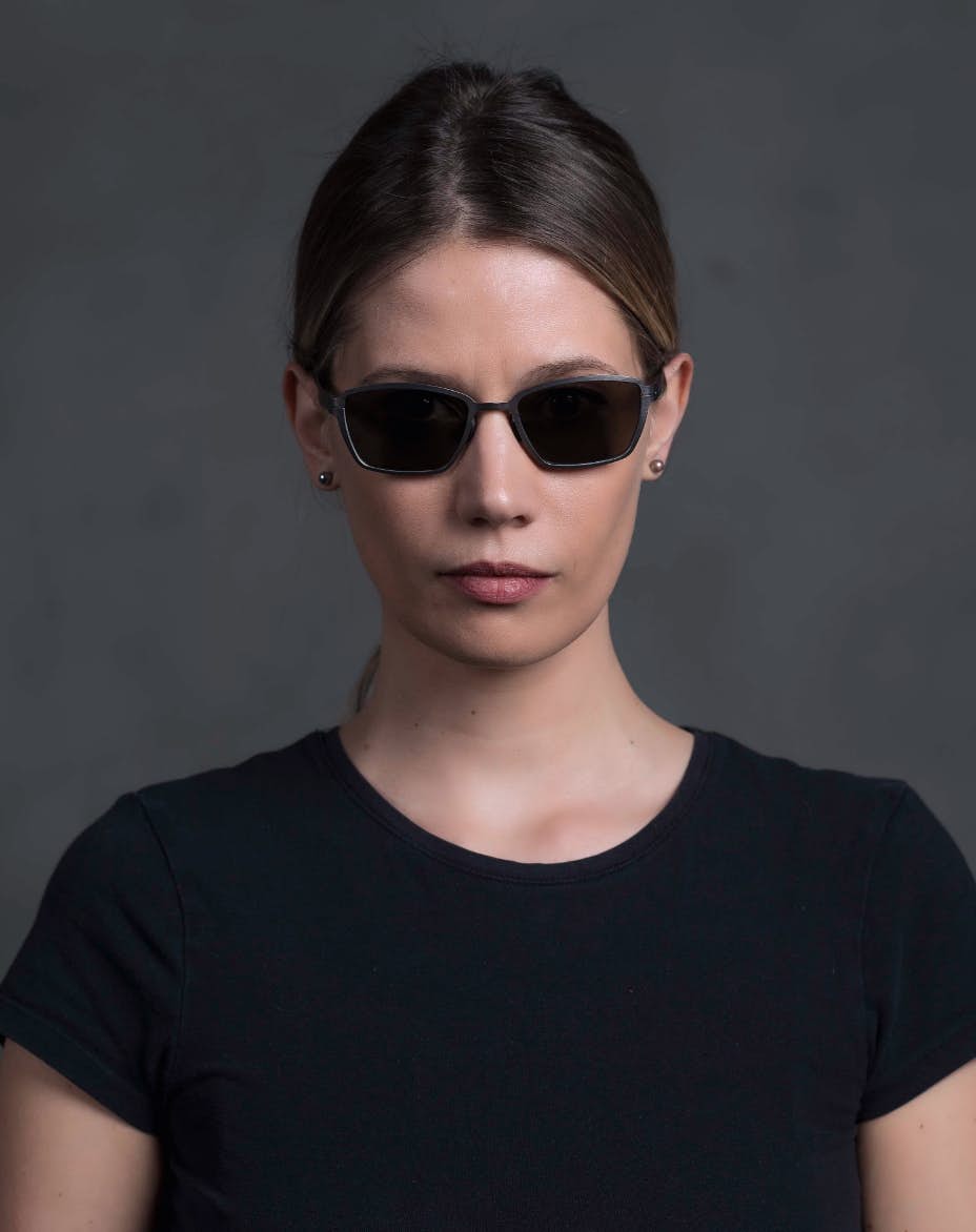 The model is wearing Pin Up Ruthenium glasses with smoke lenses