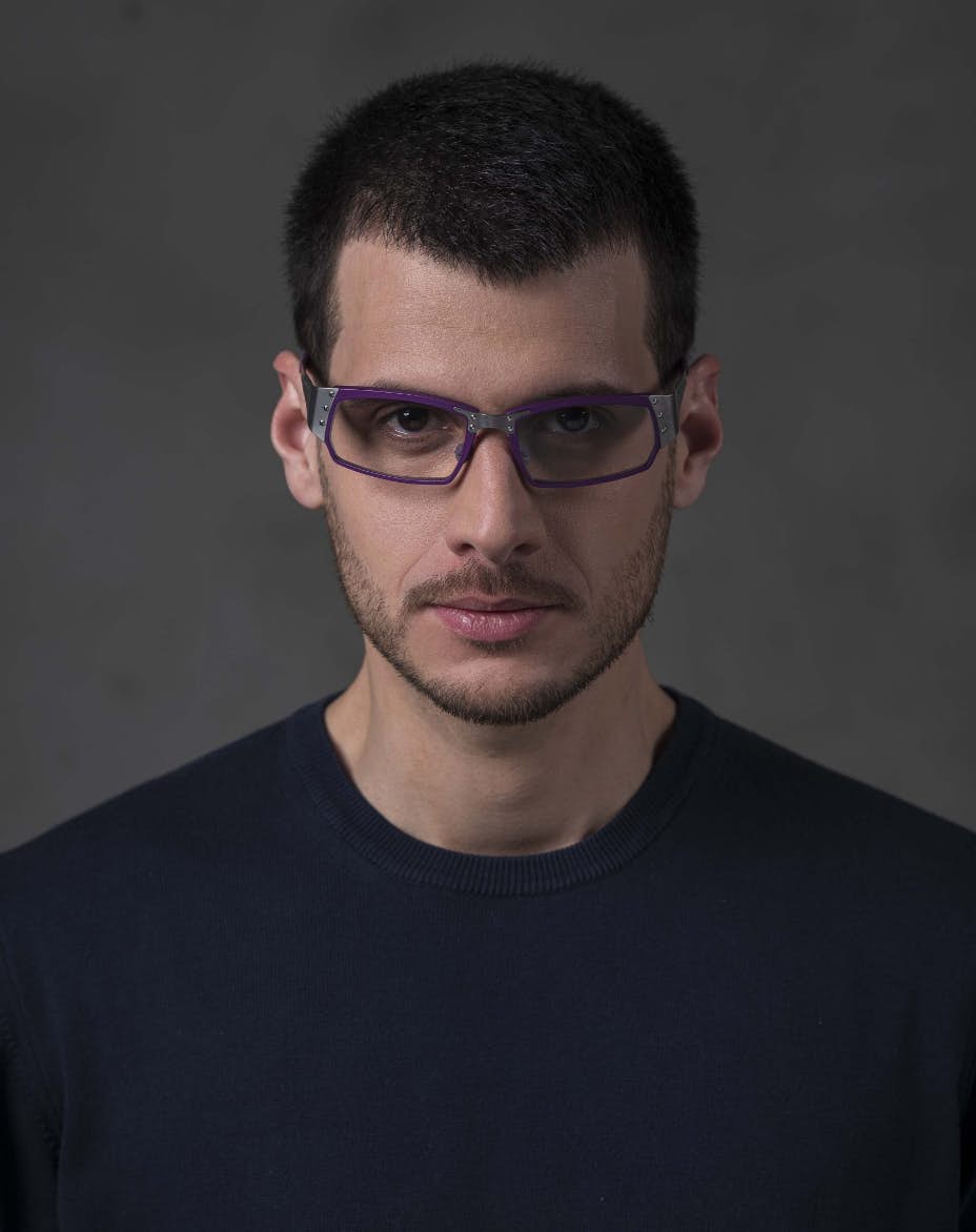 The model is wearing Touring 950 Purple glasses with vision lenses