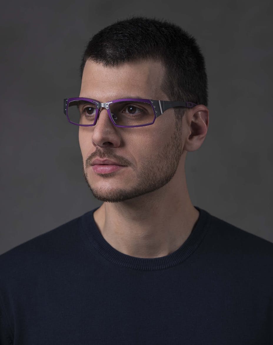 The model is wearing Touring 950 Purple glasses with vision lenses