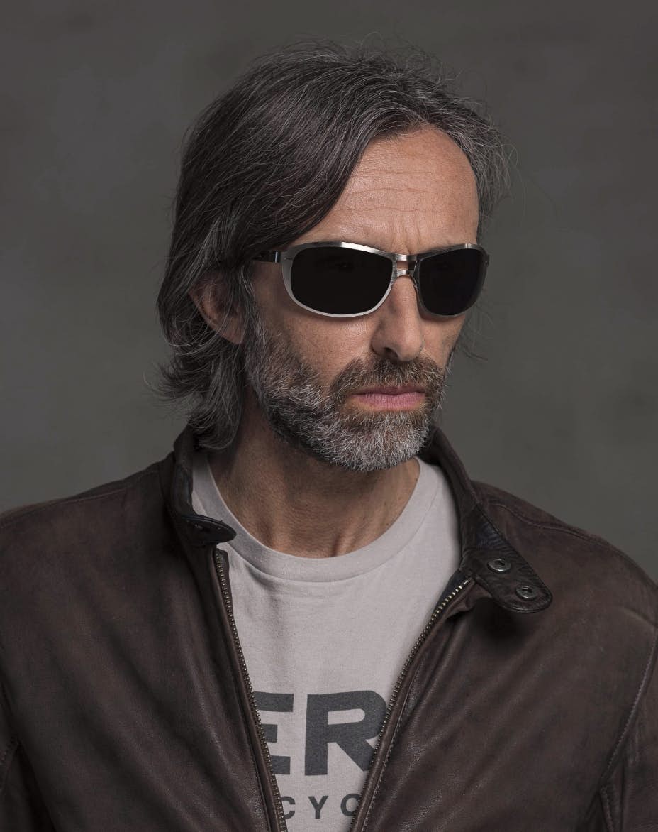 The model is wearing Special Palladium glasses with smoke lenses