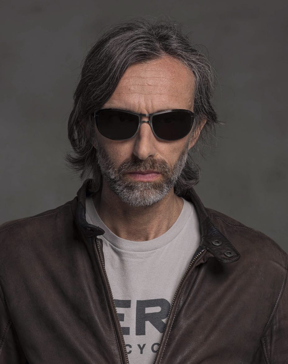 The model is wearing Special Ruthenium glasses with smoke lenses