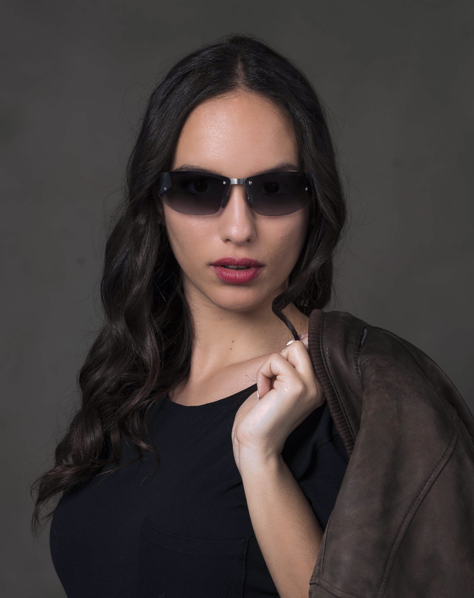 The model is wearing Gran Turismo Titanium glasses with gradient lenses
