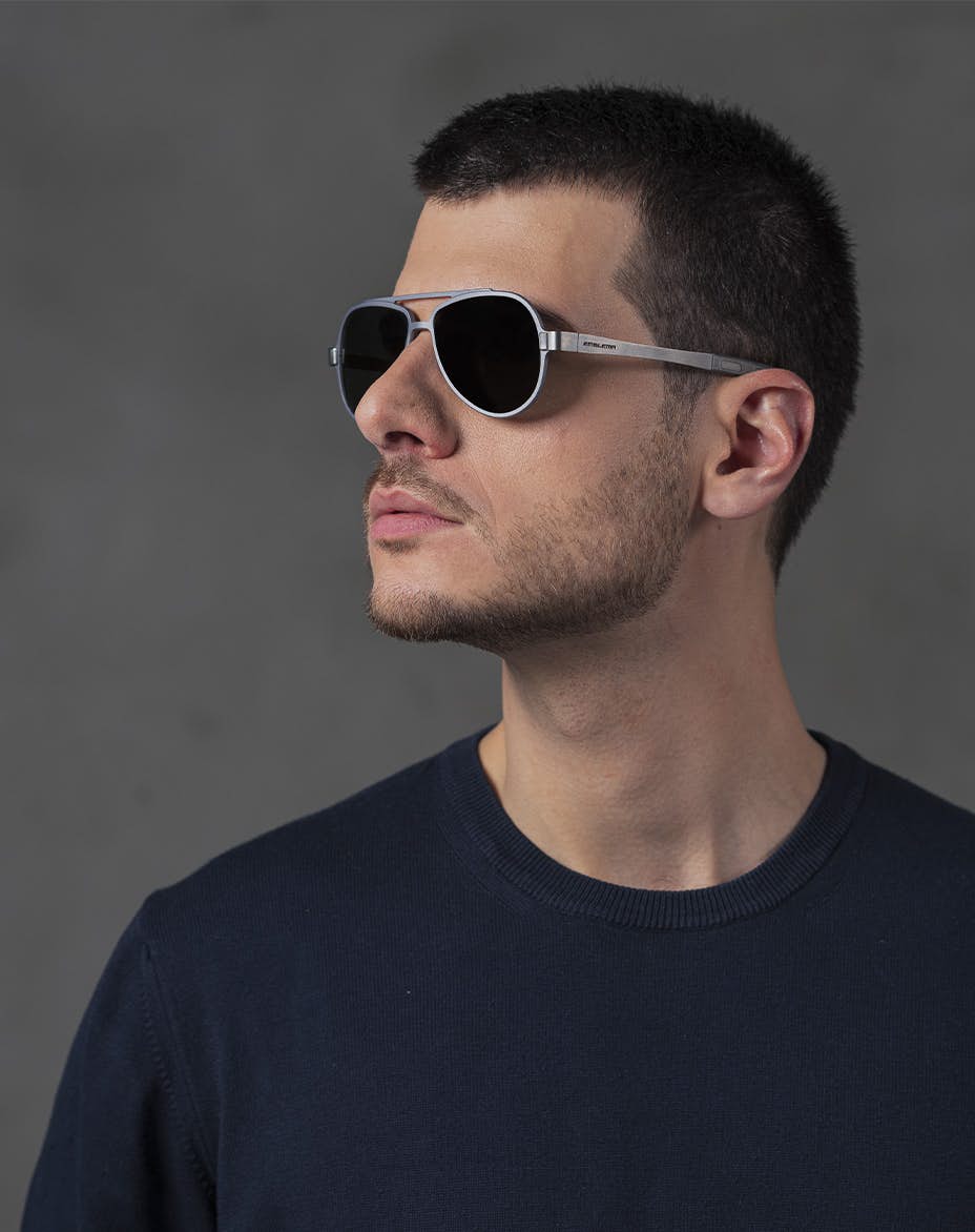 The model is wearing 820 Grey glasses with vision lenses