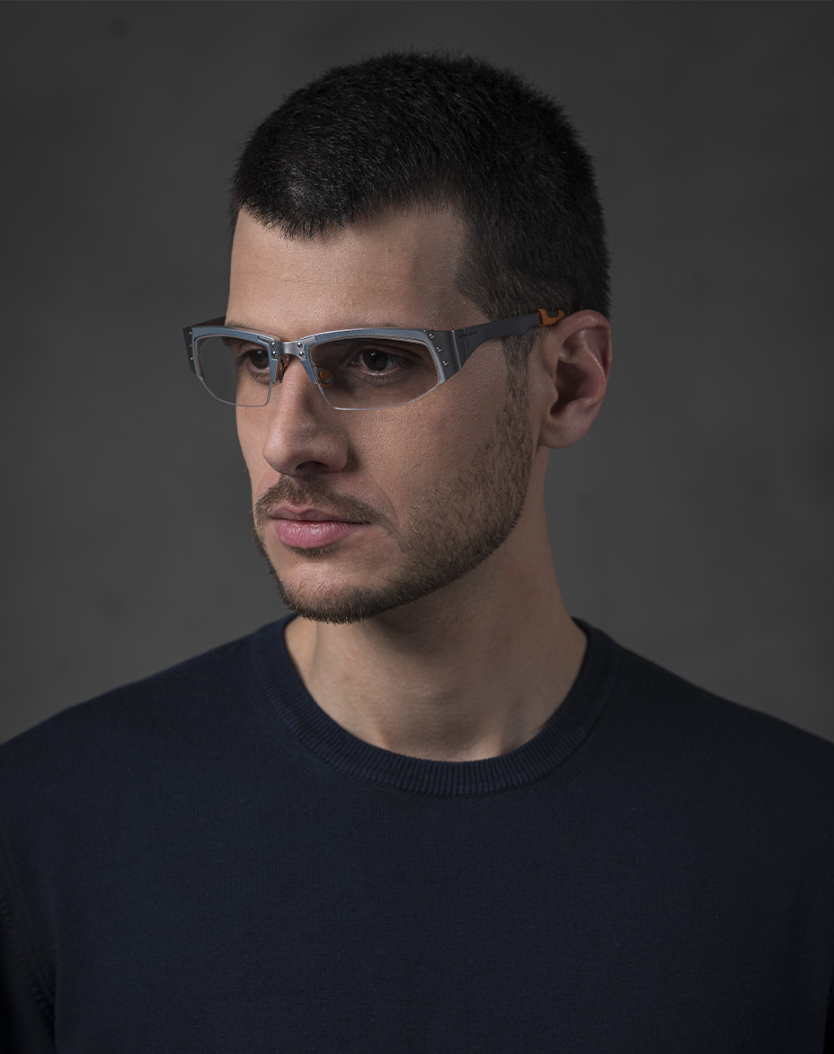 The model is wearing Touring 940 Aluminium glasses with vision lenses