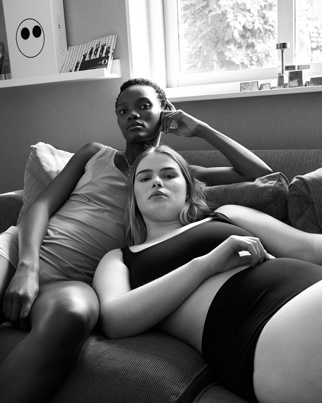 Two women on a sofa wearing period panties
