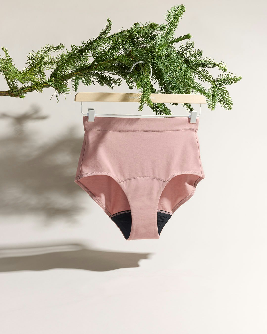 Pink period panties hanging in a tree