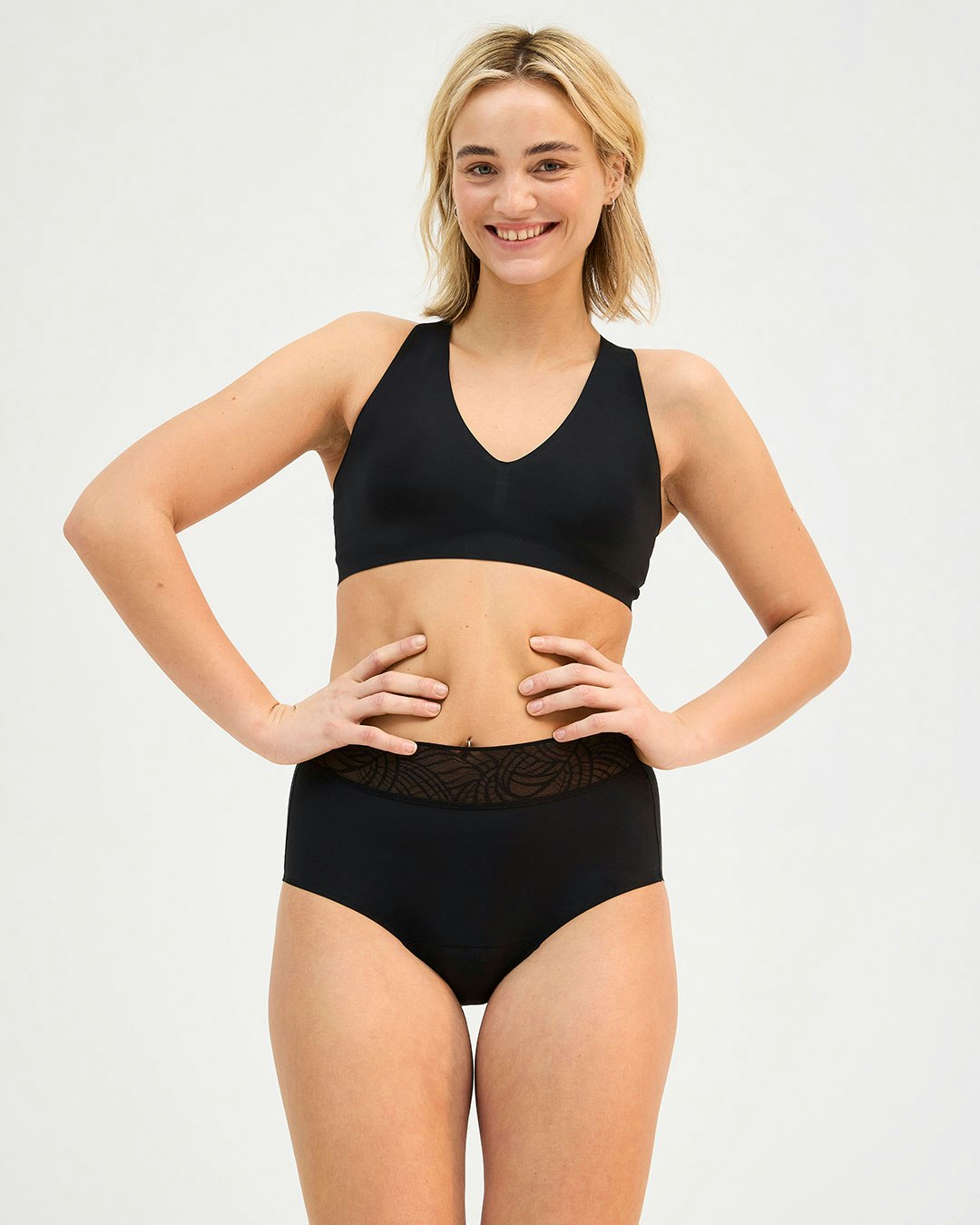 Woman in a black bra and period panties