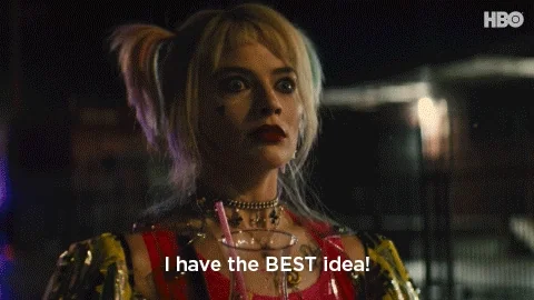 Harley Quinn character with blonde hair in pigtails, wearing heavy makeup and colorful attire, excitedly says, "I have the BEST idea!"