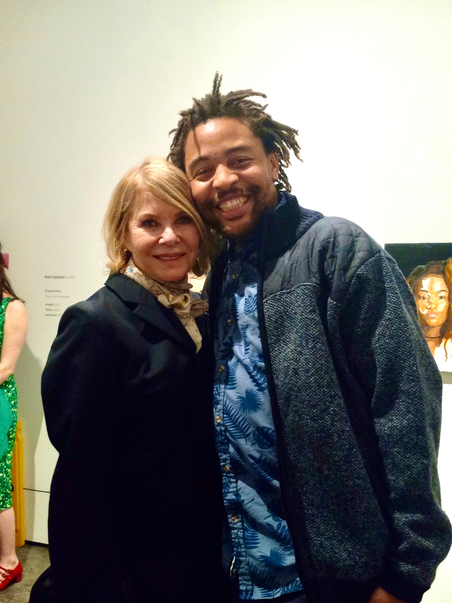 Painter Kate Capshaw and Door youth member alum Isaiah Babb reuniting at Capshaw's debut painting exhibition, which included a 2018 portrait of Isaiah.