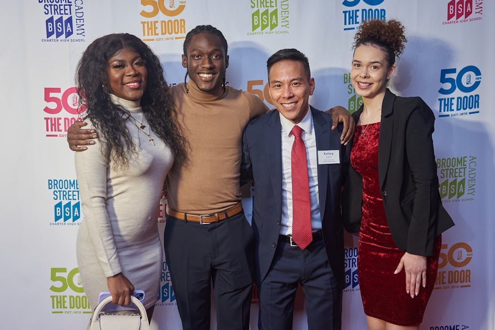 Several Door youth members and staff with CEO Kelsey Louie (second from right)