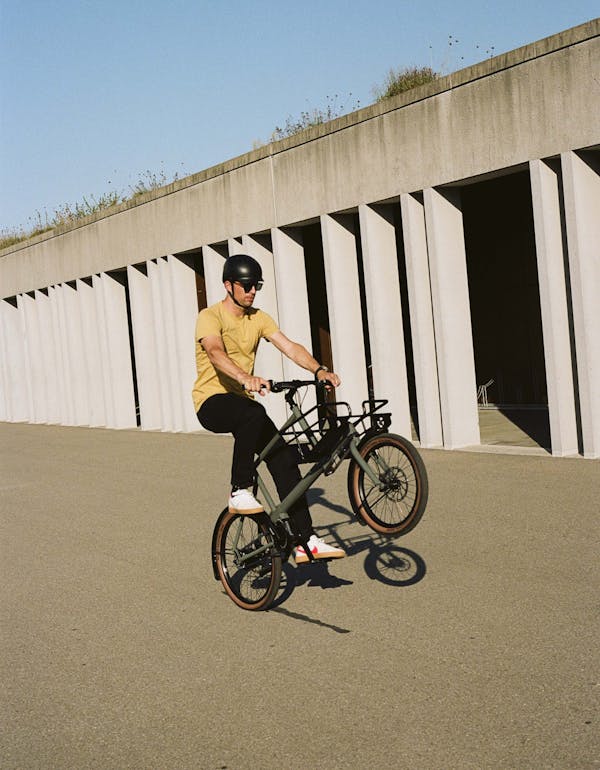 Man making a wheelie on a bike