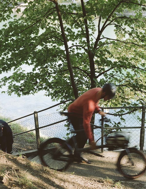 Man carrying bicycle in stairs