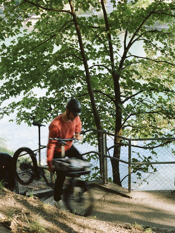 man carrying cargo bike up stairs