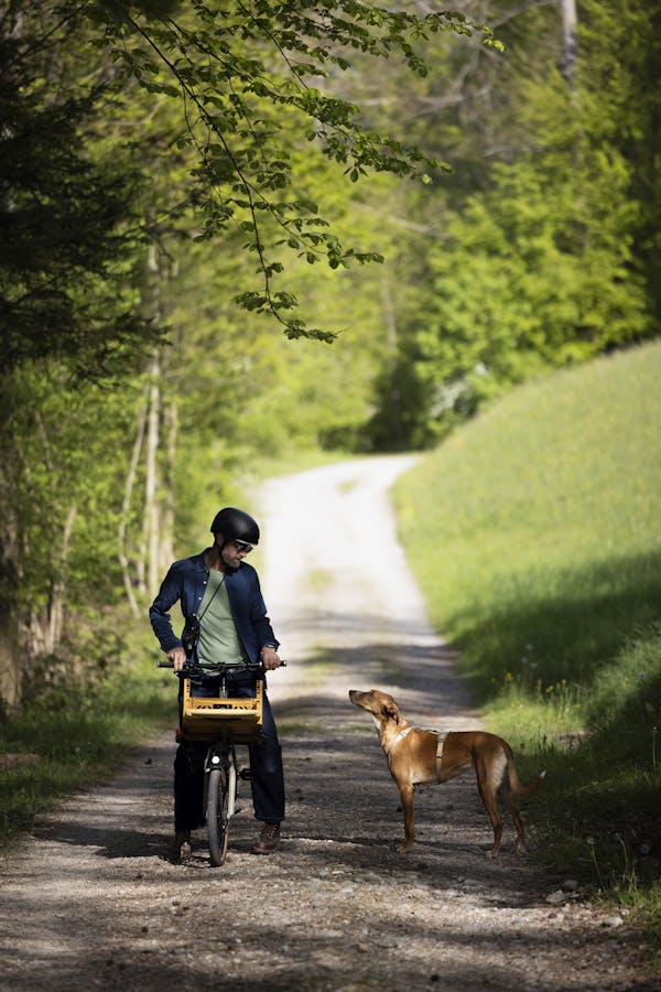 man on cargo bike and dog