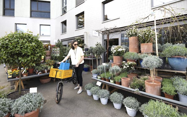 woman with cargo-bike in plant store