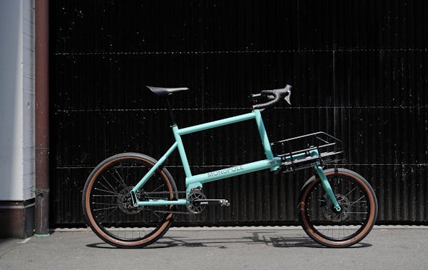 MONoPOLE No O1 drop bar blue cargo bike in front of a garage door